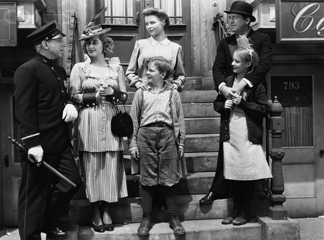 ca. 1945 --- Lloyd Nolan as Officer McShane, Joan Blondell Aunt Sissy Nolan, Dorothy McGuire as Katie Nolan, Ted Donaldson as Neeley Nolan, James Dunn as Johnny Nolan, and Peggy Ann Garner as Francie Nolan in the 1945 film A Tree Grows in Brooklyn. --- Image by © John Springer Collection/CORBIS